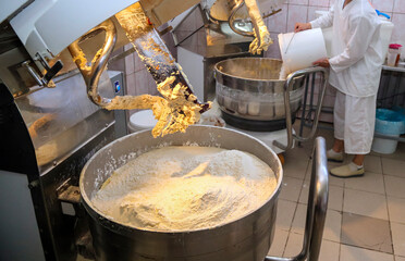 Inside a bustling biscuit factory as dough is mixed for production in a modern facility
