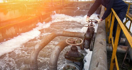 Maintenance of old water treatment plant with operator managing valves and monitoring flow