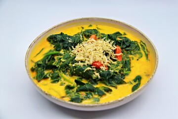 Gulai Daun Ubi is an Indonesian dish made with cassava leaves cooked in rich coconut milk and spices. A flavorful and creamy curry, popular in Sumatra and other regions.