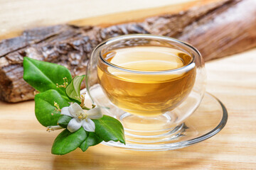 Jasmine green tea in clear cup on wooden table