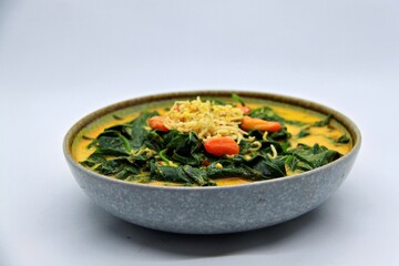 Gulai Daun Ubi is an Indonesian dish made with cassava leaves cooked in rich coconut milk and spices. A flavorful and creamy curry, popular in Sumatra and other regions.