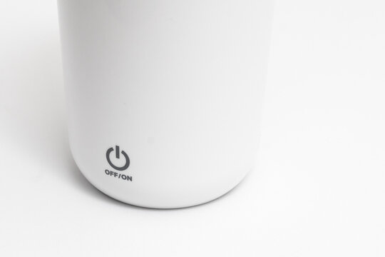 Close-up Isolated silver steel can opener bearing down on a metallic tin can with switch to open