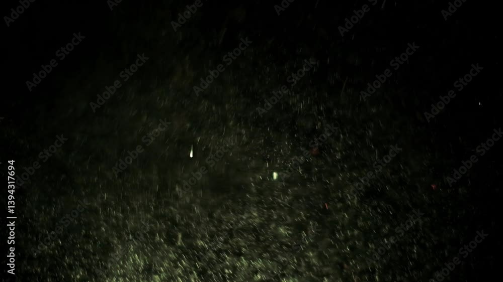 Poster glittering particles floating in dark atmosphere with subtle color highlights