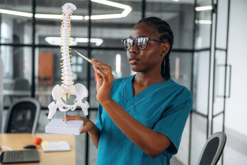 Female doctor in coat is in the office clinic