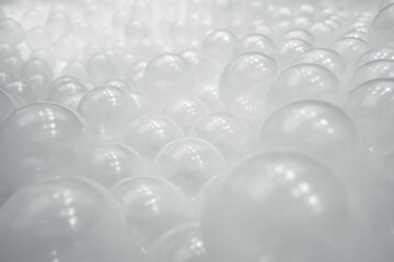 Heap of transparent plastic balls in pit playground. 