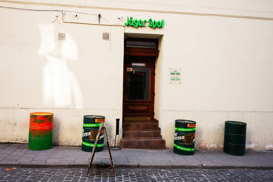 Street view of a Jager Spot building entrance with Jagermeister barrels and a sign in Lviv