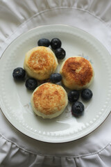 Cheesecakes with blueberries on a plate.