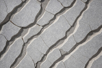 Long winding cracks in the gray wall. Repair, building construction, shrinkage