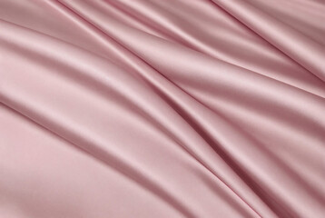 Light pink silk satin. Creases on the shiny surface of the fabric. Beautiful teal background with room for design