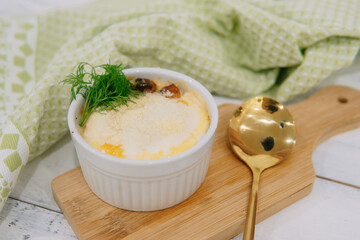 Indulge in a delectable baked dish topped with fresh dill and cheese, captured in a relaxing...