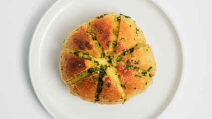 A close-up shot of freshly baked Korean cream cheese garlic bread, showcasing its soft, golden-brown exterior and the generous filling of creamy cheese and fragrant garlic butter.