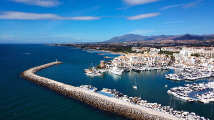 aerial view of luxury yachts in Puerto Ban&uacute;s marina, habor wall and the lighthouse Faro Puerto Ban&uacute;s, mountains behind, Marbella, Malaga, Andalusia, Costa del Sol, Spain