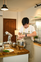 Man preparing whipped cream with stand mixer in home kitchen