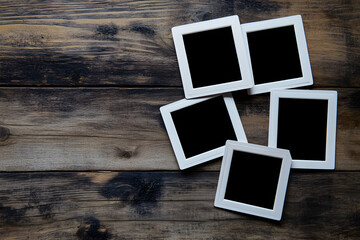 Blank vintage photo frames on rustic wooden table background. Old memories concept, nostalgic photography layout, scrapbook placeholder, retro style photo mockup template