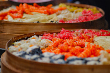 Colorful steamed dim sum, Various kinds of sushi for sale in market, Selective of focus, typical...