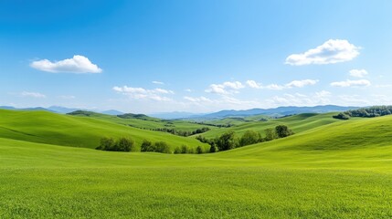 Fototapeta premium Lush green hills under a vibrant blue sky