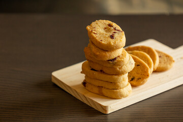 freshly baked orange and cranberry cookies arranged on a dark background