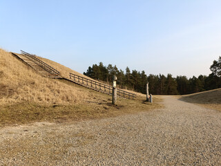 Salduve hill during sunny day. Small hill. Grass is growing on hill. Staircase leading to the top....