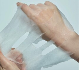 The hand of the woman who is opening the mask pack