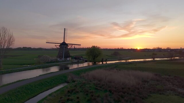 Aerial View of a Historic Dutch Windmill and the River Gein at Sunset in Abcoude Village