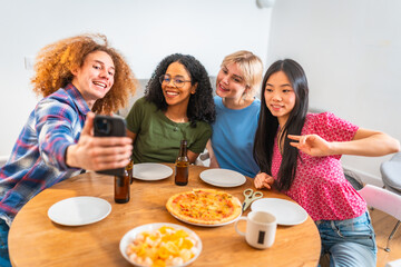 Friends taking selfie while having lunch together at home