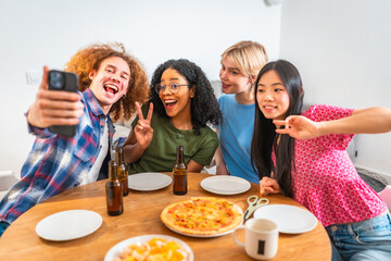 Cheerful friends taking selfie while enjoying pizza and beer at home