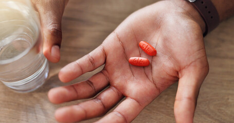 Above, medicine or hands with pills, vitamin supplements and medical prescription in home. Glass, wellness and healthcare tablets for virus, sick person with medication, water or pharmaceutical drugs