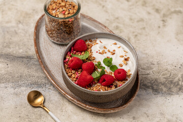 yogurt with granola and raspberries, breakfast