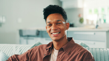 Portrait, smile and man relax in apartment for peace, calm and break on weekend in lounge. Sofa, confident and happy male person in living room for comfort, resting and chilling in home in Brazil