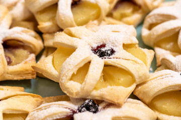 Freshly baked fruit puff pastries on the ceramic plate. Baking