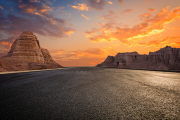 Asphalt road and Yardang landform mountain with beautiful sky clouds at sunset