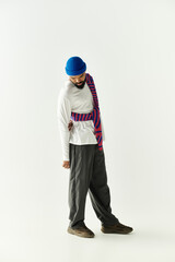 Stylish young man exuding charm in a modern fashion pose against a minimalist backdrop