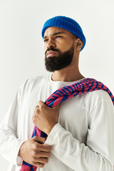 Stylish young man with a bold fashion statement poses confidently in a minimalist studio