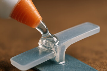 close up of glue applicator dispensing adhesive onto surface highlights concept of rework and repair, showcasing not good ng application