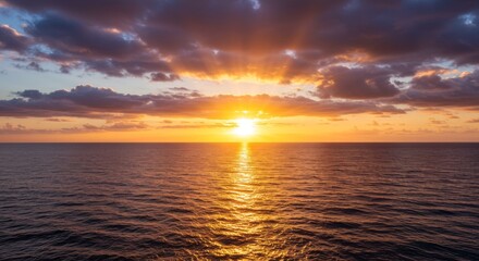 Obraz premium Serene Ocean Sunset - A breathtaking sunset over a calm ocean, with vibrant colors painting the sky and reflecting on the water