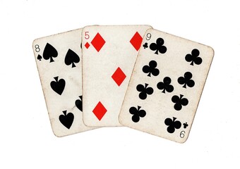 A hand of three vintage playing cards isolated on a white background.