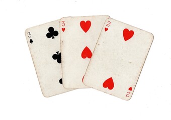 Obraz premium A hand of three vintage playing cards isolated on a white background.