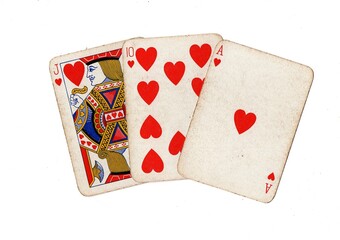 A hand of three vintage playing cards isolated on a white background.