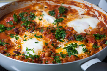 eggs and beans dinner in a pan close-up