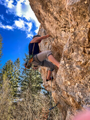  Young Girl Lead-Climbing on a Steep Rock Face: A Thrilling Ascent in the German Alps with Stunning Views and Rugged Limestone Formations