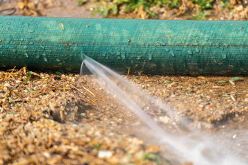 Water leaking from hole in a industrial hose.