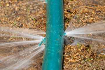 Water leaking from hole in a industrial hose.