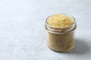 Raw brown rice in a jar on the table