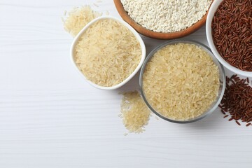 Different types of rice in bowls on table, closeup