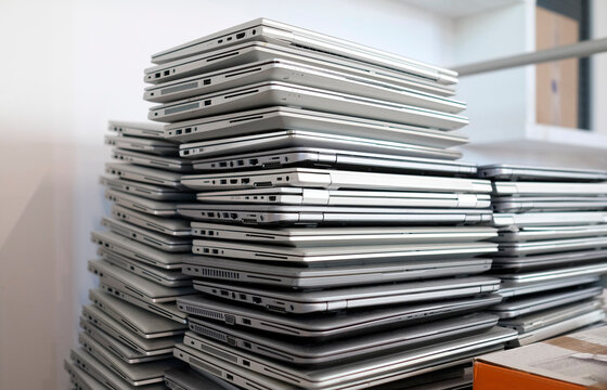 Electronic waste - stack of laptops to be discarded