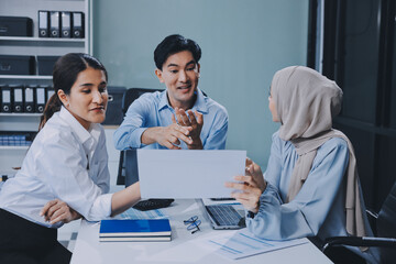 Fototapeta premium Diverse international executive business partners group discuss report at boardroom meeting table. Multiracial team negotiating project developing business strategy doing paperwork analysis in office.