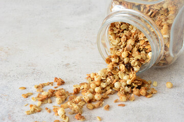 Delicious homemade granola spilled from a jar