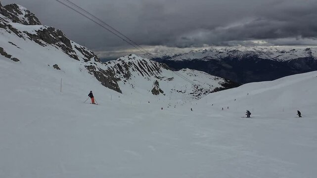 Skiers on a slope in the ski resort of Courchevel, France