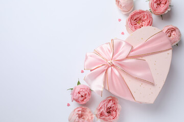 Beautiful pink peony roses with gift box on a white background