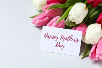 Happy Mother's day. Beautiful bouquet of fresh tulips on a colored background